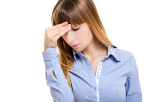 Woman having a headache isolated on white